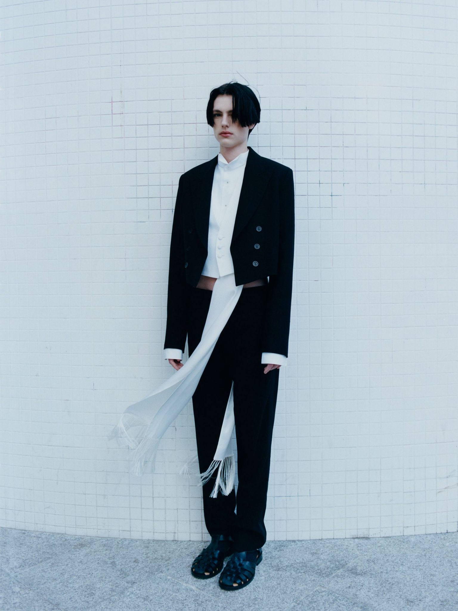 vo0326_dior_03 Image may contain Clothing Formal Wear Suit Blazer Coat Jacket Person Standing Pants Adult and Tuxedo