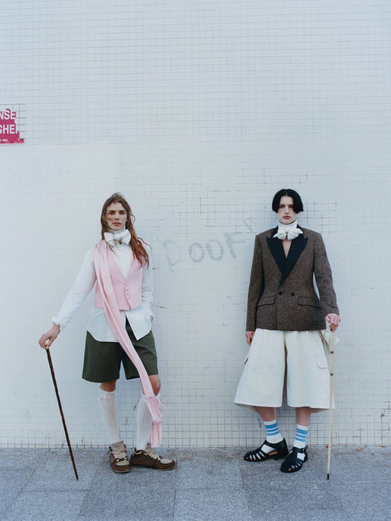 vo0326_dior_07 Image may contain Person Teen Clothing Coat Blazer Jacket Footwear Shoe Skirt Long Sleeve Sleeve and Shorts