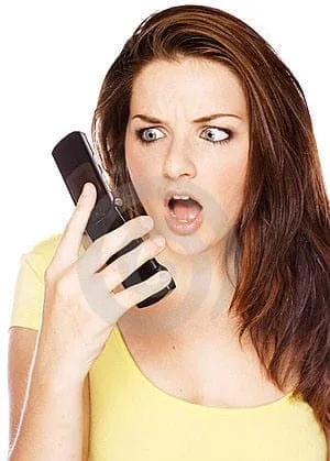 woman looking shocked at her phone thumb11063485 jpg