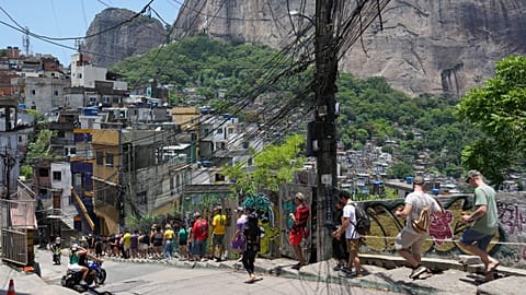 Tourists visit the Rocinha favela, as Rio de Janeiro recorded a record number of international tourists in 2025, Tuesday, Jan. 27, 2026.