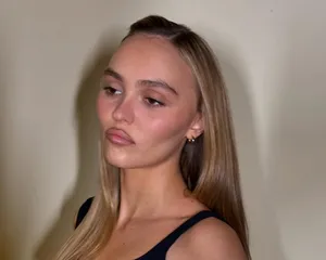 Lily-Rose Depp with a cool-toned light brown "milk tea" hair color and neutral makeup