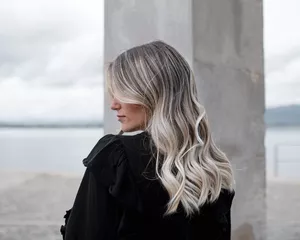 A woman with cool-toned blonde hair